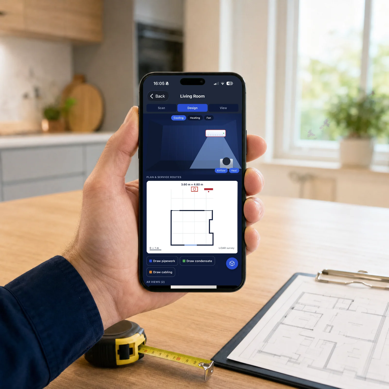 A hand holding an iPhone over a kitchen worktop, the Vento app showing a 3.60 m by 4.80 m room plan with service routes, marked LiDAR survey