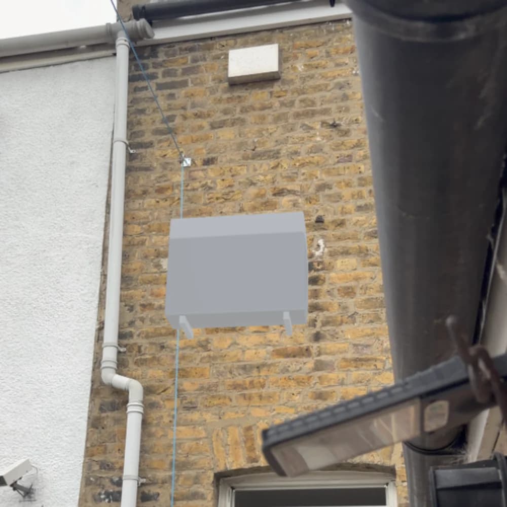 Augmented reality view of a condenser unit on a real brick external wall
